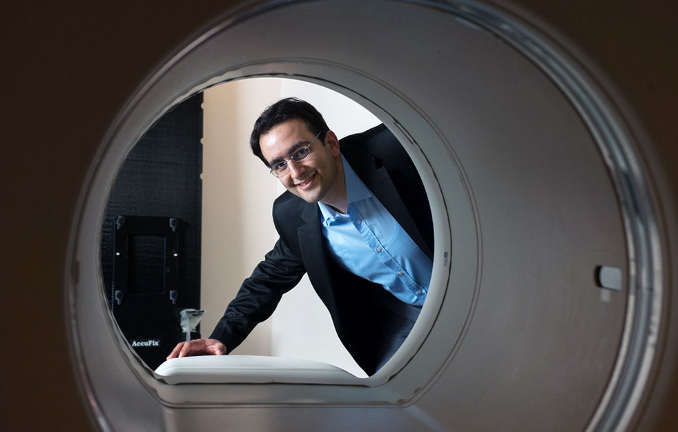a Georgia Tech researcher looks inside a Micro-computed tomography (micro-CT) machine