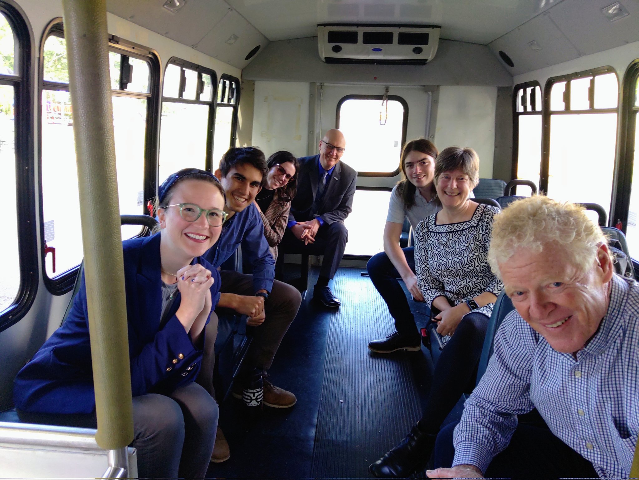 Individuals taking picture in the bus