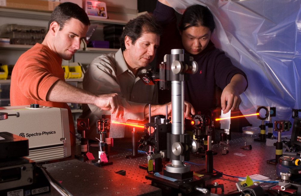 Researchers work with laser technology to develop an innovative product.