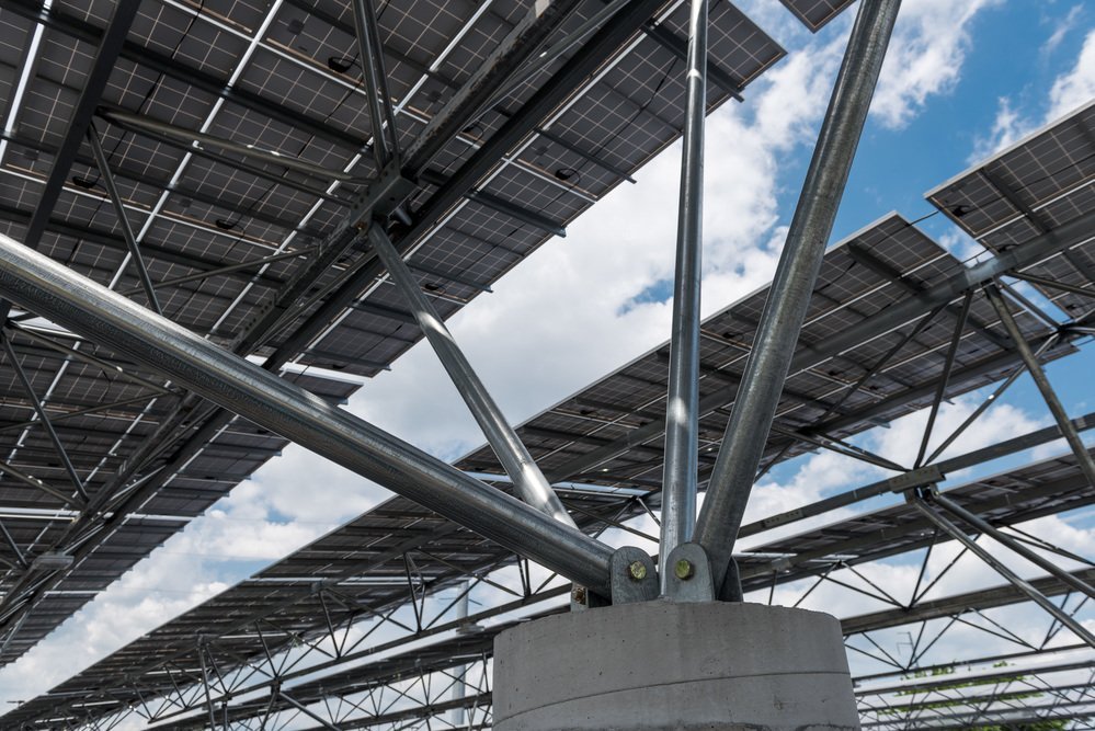 A view from under solar panels and the sky.