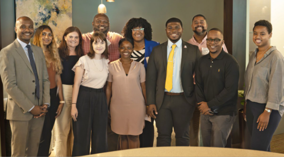 Clarence Anthony, Jr. stands with a group of fellows engaging in the fellowship program.